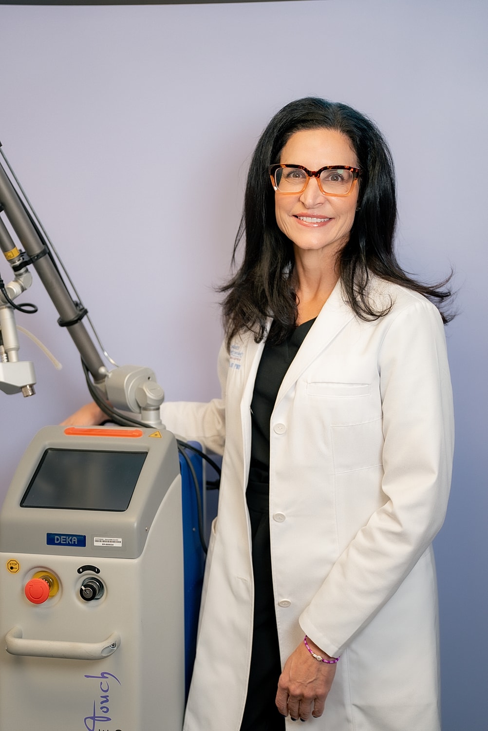 Medical professional with laser equipment background.