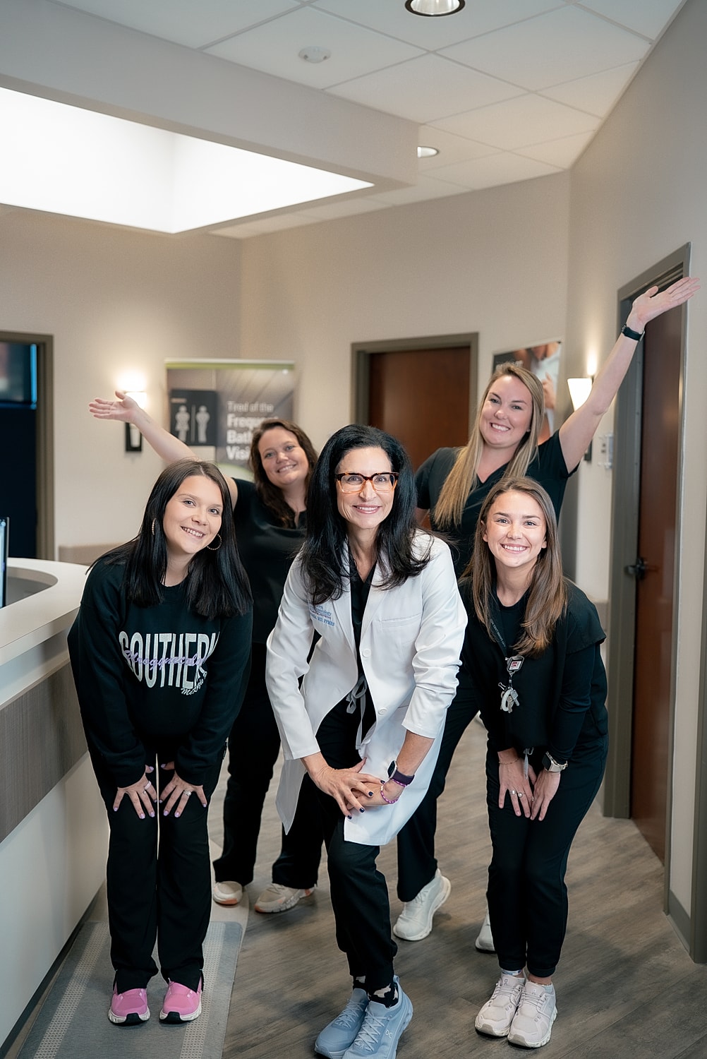 Cheerful healthcare team posing in office setting.
