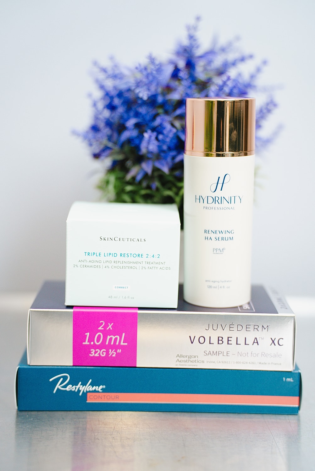 Skincare products with flowers in background.