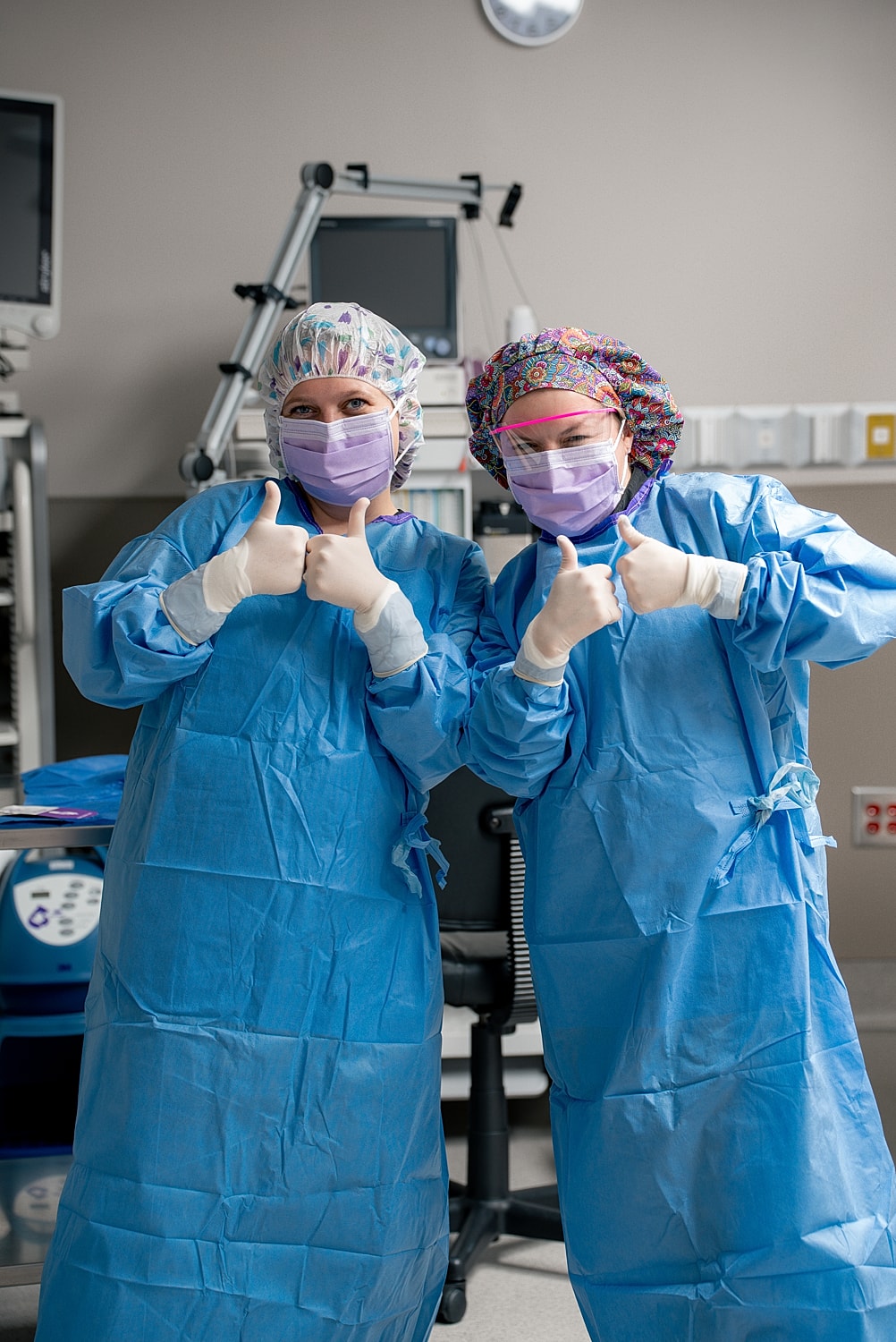 Two healthcare workers giving thumbs up.