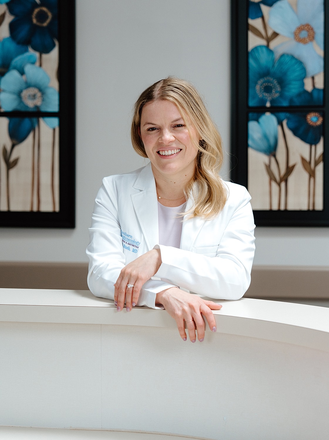 Medical professional smiling in a clinical setting.