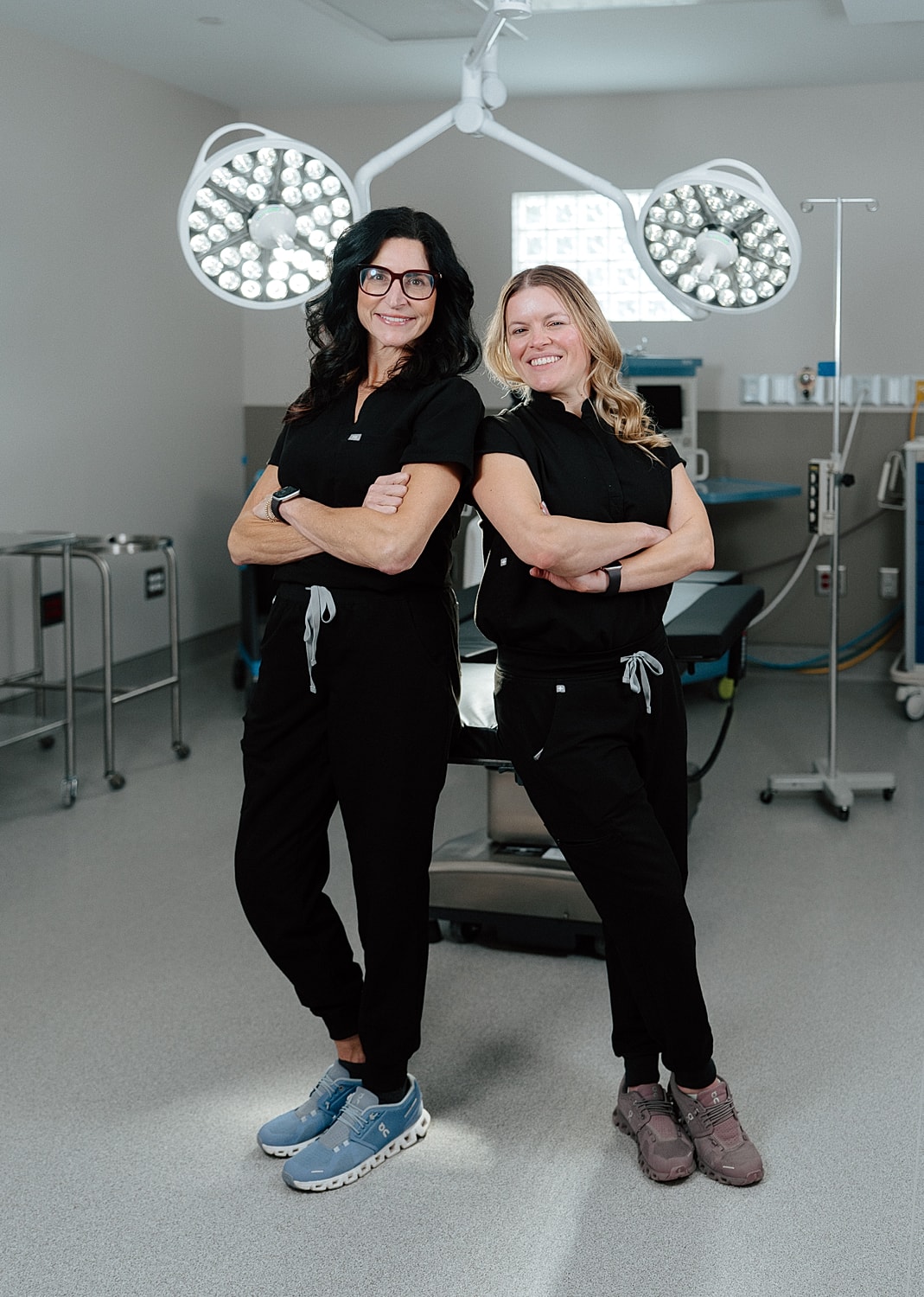 Two women in scrubs in an operating room.