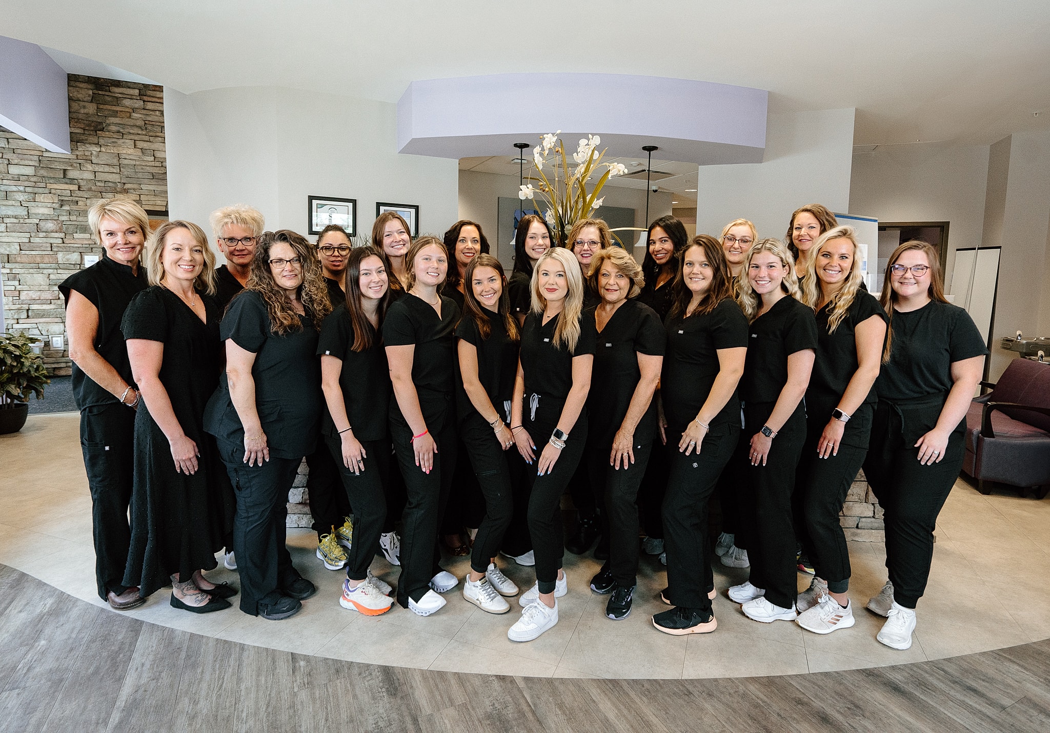 Group of healthcare professionals in black scrubs.